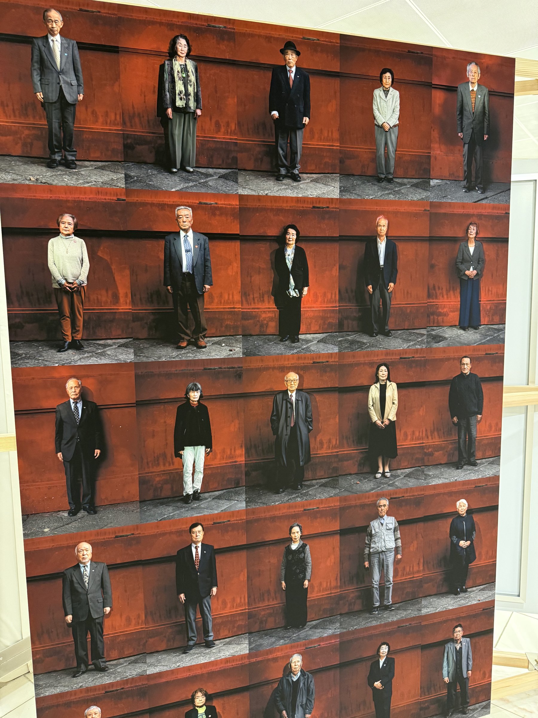 Full wall of hibakusha portraits aboard Peace Boat